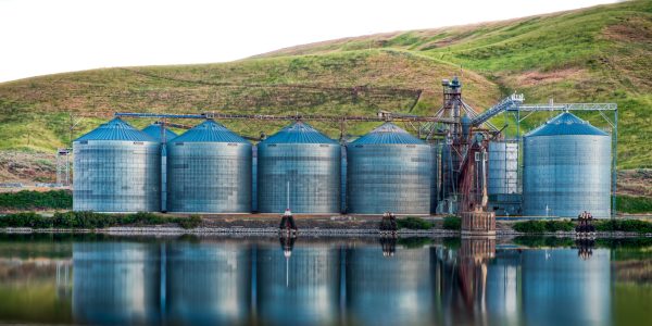 Panoramic shot of industrial buildings on the shore of the lake reflected in the water A panoramic shot of industrial buildings on the shore of the lake reflected in the water